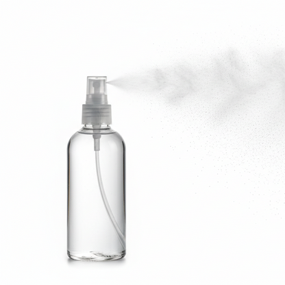 Clear spray bottle with mist on a white background